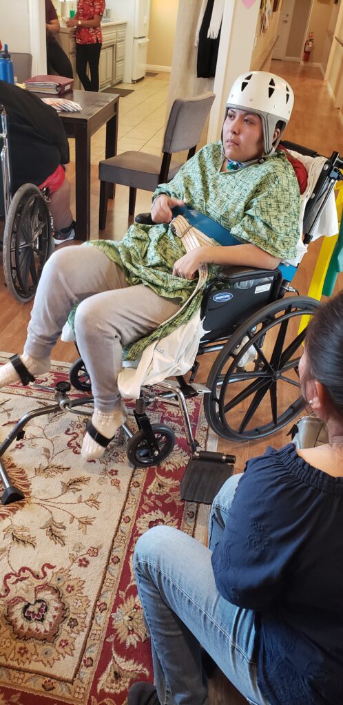 A person in a wheelchair with a cane.